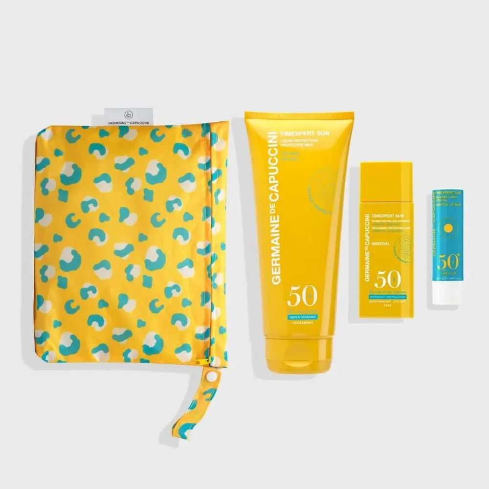 Kit con leche protectora SPF50, fluido protector antiedad SPF50, bálsamo labial SPF50+ y neceser